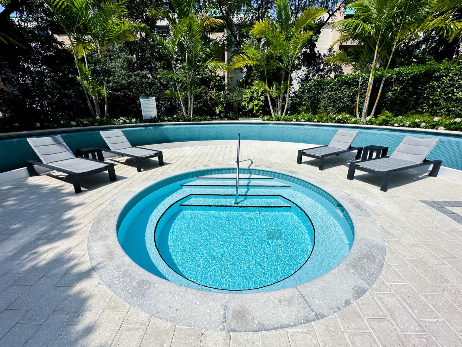 Circular spa and water feature with loungers